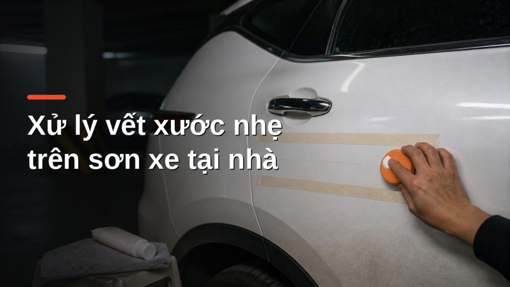 Dùng pad xốp và kem đánh bóng xử lý vết xước nhẹ trên cửa xe sơn trắng, khu vực được khoanh bằng băng keo giấy